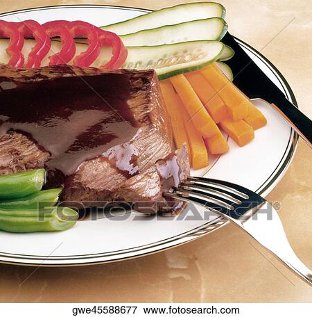 Stock Photo - Close-up of meat and vegetables in a plate. Fotosearch
