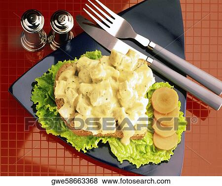 Stock Photo - Close-up of meat covered with cheese sauce. Fotosearch