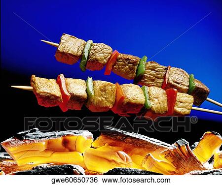 Close-up of meat on a skewer cooking above coal View Large Photo Image Stock Photograph - Close-up of meat on a skewer cooking above coal. Fotosearch