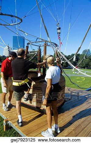 Close-up of men climbing into a hot air balloon basket, Boston, Massachusetts, USA View Large Photo Image Stock Photography - Close-up of men climbing into a hot air balloon basket, Boston, Massachusetts, USA. Fotosearch