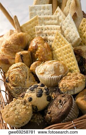 Stock Image - Close-up of muffins and crackers in a wicker basket. Fotosearch