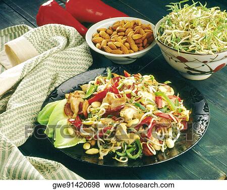 Stock Photo - Close-up of noodles near a bowl of almonds. Fotosearch