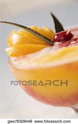 Stock Photo - Close-up of orange juice in a stem glass. Fotosearch
