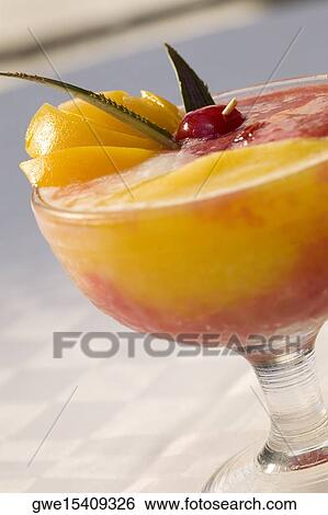 Stock Photograph - Close-up of orange juice in a stem glass. Fotosearch
