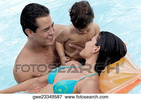 Close-up of parents with their son in a swimming pool View Large Photo Image Stock Photo - Close-up of parents with their son in a swimming pool. Fotosearch