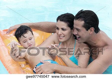 Close-up of parents with their son in a swimming pool View Large Photo Image Stock Photo - Close-up of parents with their son in a swimming pool. Fotosearch