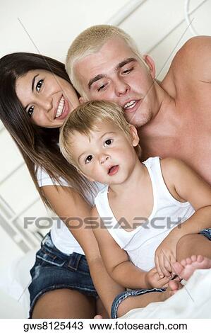 Close-up of parents with their son View Large Photo Image Stock Image - Close-up of parents with their son. Fotosearch