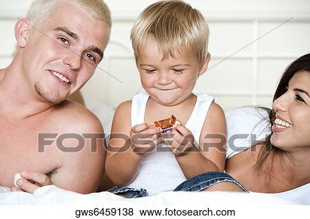Close-up of parents with their son holding candy View Large Photo Image Stock Photo - Close-up of parents with their son holding candy. Fotosearch