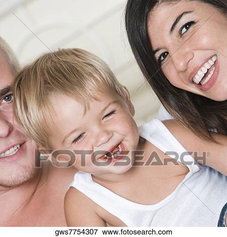Close-up of parents with their son View Large Photo Image Stock Photo - Close-up of parents with their son. Fotosearch