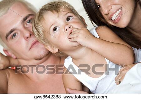 Close-up of parents with their son View Large Photo Image Stock Photo - Close-up of parents with their son. Fotosearch