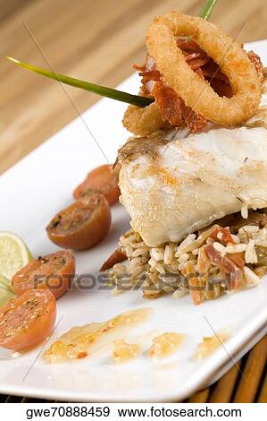 Stock Photo - Close-up of rice and tomato slices in a plate. Fotosearch