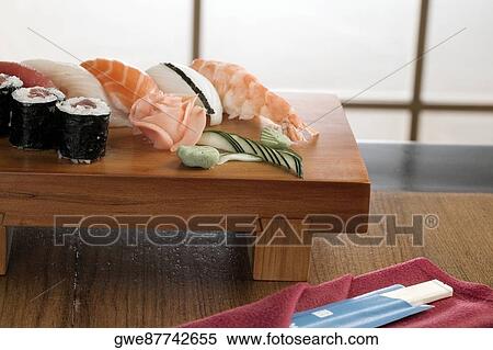 Stock Photography - Close-up of sushi and fish on a table. Fotosearch