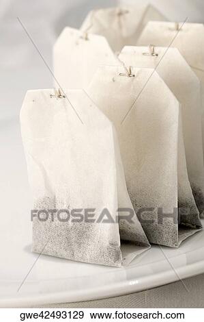Stock Photo - Close-up of teabags in a plate. Fotosearch