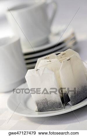Stock Photo - Close-up of teabags in a plate. Fotosearch