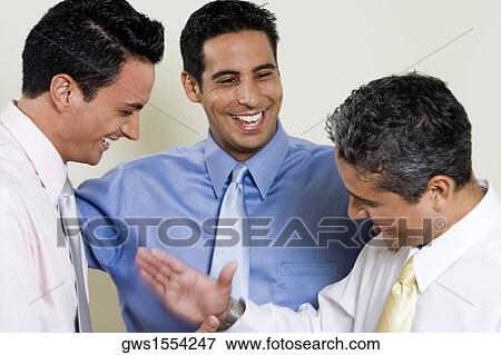 Close-up of three businessmen smiling View Large Photo Image Stock Photo - Close-up of three businessmen smiling. Fotosearch