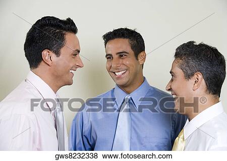Close-up of three businessmen smiling View Large Photo Image Stock Photo - Close-up of three businessmen smiling. Fotosearch