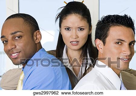 Stock Image - Close-up of two businessmen with a businesswoman. Fotosearch