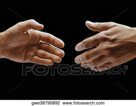 Close-up of two hands reaching towards each other View Large Photo Image Stock Image - Close-up of two hands reaching towards each other. Fotosearch