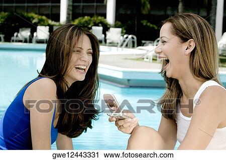 Close-up of two young women laughing View Large Photo Image Stock Image - Close-up of two young women laughing. Fotosearch