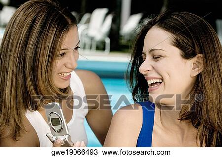 Stock Image - Close-up of two young women smiling. Fotosearch
