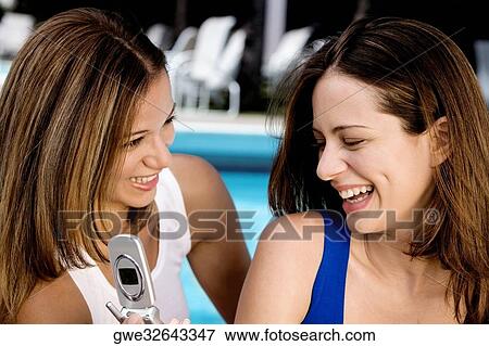 Stock Photo - Close-up of two young women smiling. Fotosearch