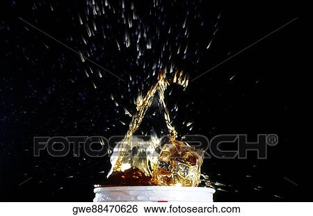 Close-up of water splashing out of a glass View Large Photo Image Stock Photograph - Close-up of water splashing out of a glass. Fotosearch