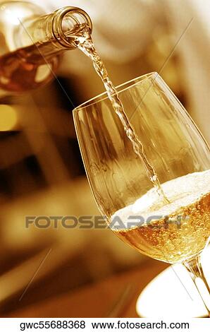 Close-up of wine being poured into a wineglass View Large Photo Image Stock Photo - Close-up of wine being poured into a wineglass. Fotosearch