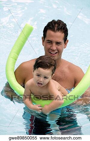 Father teaching his son how to swim in a swimming pool View Large Photo Image Stock Photography - Father teaching his son how to swim in a swimming pool. Fotosearch