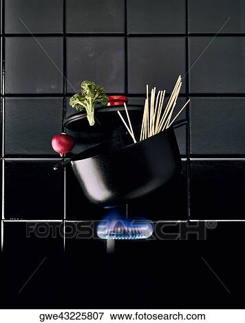 Stock Photo - Fettuccini in a pan on a flame. Fotosearch