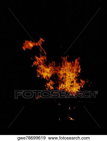 Flames of a fire at night View Large Photo Image Stock Photo - Flames of a fire at night. Fotosearch