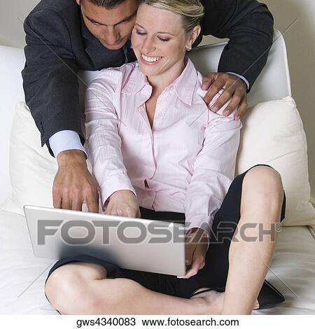 High angle view of a businessman and a businesswoman using a laptop View Large Photo Image Stock Image - High angle view of a businessman and a businesswoman using a laptop. Fotosearch