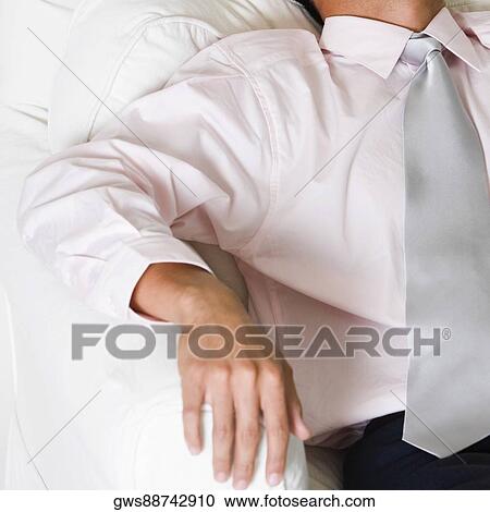 High angle view of a businessman sleeping in an armchair View Large Photo Image Stock Image - High angle view of a businessman sleeping in an armchair. Fotosearch