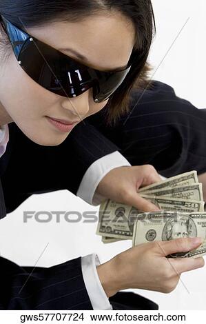High angle view of a businesswoman holding American paper currency View Large Photo Image Picture - High angle view of a businesswoman holding American paper currency. Fotosearch