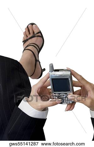High angle view of a businesswoman holding a mobile phone View Large Photo Image Stock Photo - High angle view of a businesswoman holding a mobile phone. Fotosearch