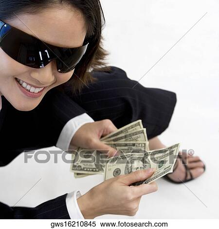 High angle view of a businesswoman holding American paper currency View Large Photo Image Stock Photography - High angle view of a businesswoman holding American paper currency. Fotosearch