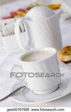 High angle view of a coffee cup and a kettle View Large Photo Image Stock Photograph - High angle view of a coffee cup and a kettle. Fotosearch