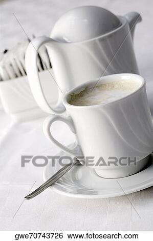 High angle view of a coffee cup and a kettle View Large Photo Image Stock Photograph - High angle view of a coffee cup and a kettle. Fotosearch