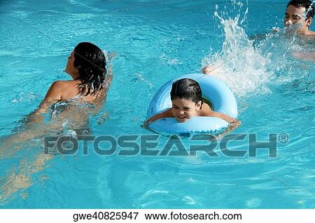 High angle view of a family in a swimming pool View Large Photo Image Stock Photo - High angle view of a family in a swimming pool. Fotosearch