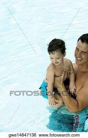 High angle view of a father with his son in a swimming pool View Large Photo Image Stock Photograph - High angle view of a father with his son in a swimming pool. Fotosearch