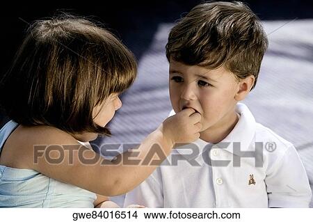 High angle view of a girl feeding her brother View Large Photo Image Picture - High angle view of a girl feeding her brother. Fotosearch