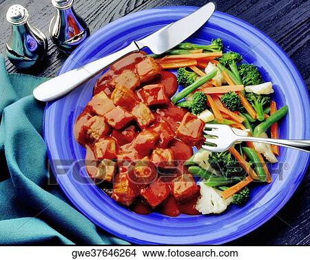 High angle view of a meta dish with gravy and salad View Large Photo Image Picture - High angle view of a meta dish with gravy and salad. Fotosearch
