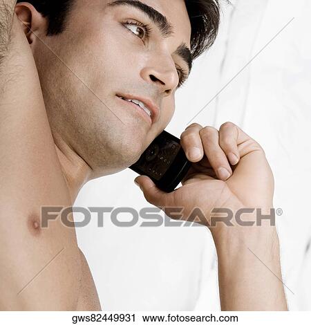 High angle view of a mid adult man talking on a mobile phone View Large Photo Image Stock Image - High angle view of a mid adult man talking on a mobile phone. Fotosearch