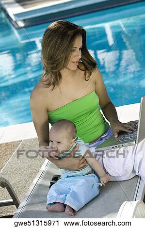 High angle view of a mother sitting with her daughter View Large Photo Image Stock Image - High angle view of a mother sitting with her daughter. Fotosearch