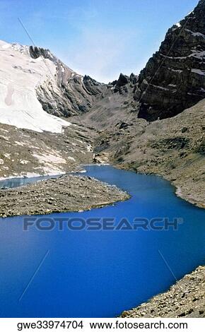 High angle view of a pond surrounded by mountains View Large Photo Image Picture - High angle view of a pond surrounded by mountains. Fotosearch