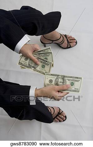 High angle view of a woman holding American dollar bills View Large Photo Image Stock Image - High angle view of a woman holding American dollar bills. Fotosearch