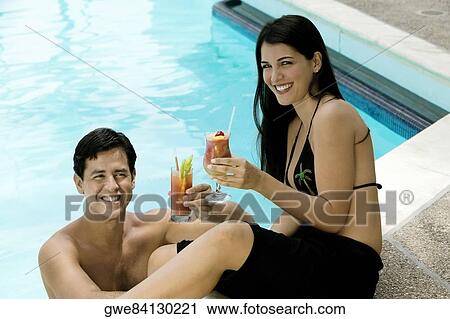 High angle view of a young couple holding drinks View Large Photo Image Stock Image - High angle view of a young couple holding drinks. Fotosearch