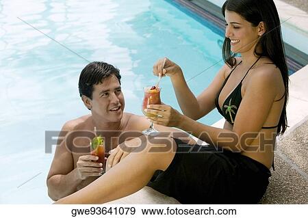 High angle view of a young couple holding drinks View Large Photo Image Stock Photo - High angle view of a young couple holding drinks. Fotosearch