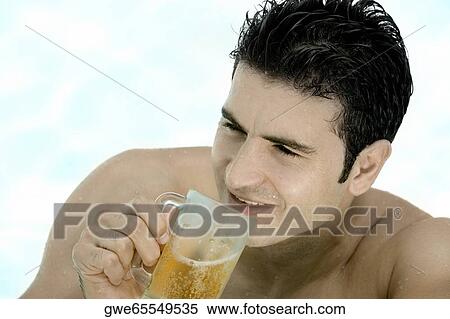 High angle view of a young man holding a mug of beer View Large Photo Image Stock Photography - High angle view of a young man holding a mug of beer. Fotosearch