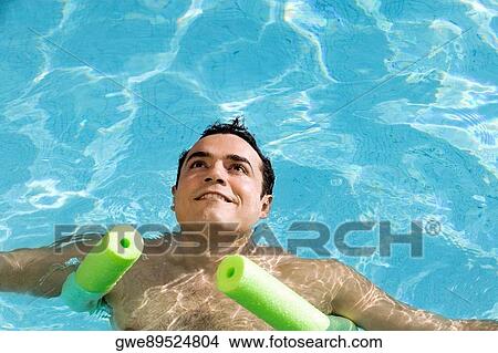 High angle view of a young man in a swimming pool View Large Photo Image Picture - High angle view of a young man in a swimming pool. Fotosearch