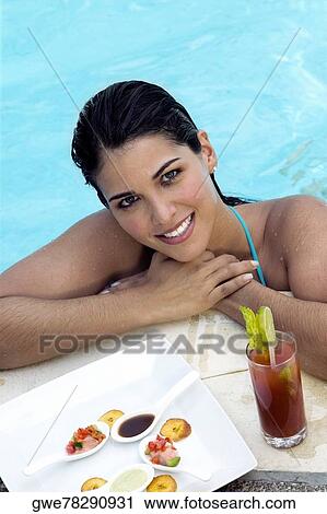 High angle view of a young woman in a swimming pool View Large Photo Image Stock Image - High angle view of a young woman in a swimming pool. Fotosearch